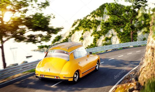 Car on a palm-lined road near the beach