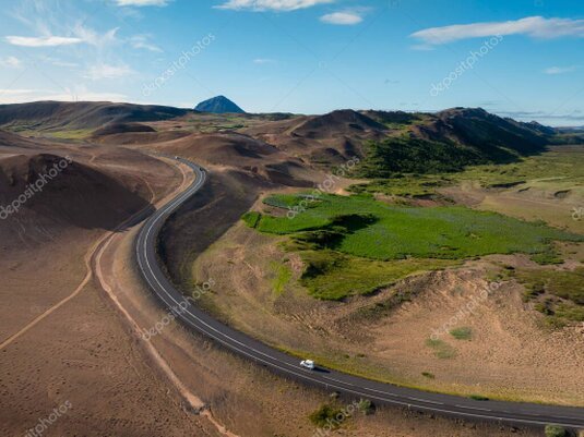 Car on a road crossing a volcanic landscape