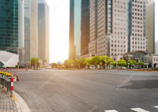 Car driving on a road with a city skyline in the background